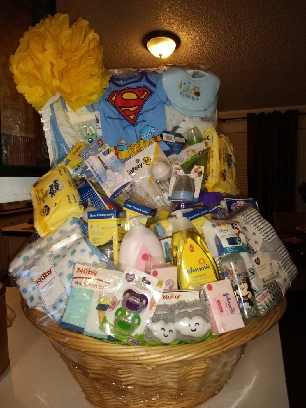 Baby boy gift basket with baby clothes, toys, and baby essentials