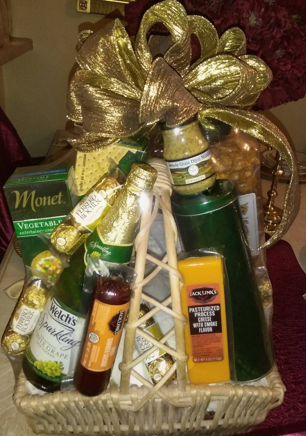 Gourmet gift basket with sparkling white grape juice, cheese, sausage, and Ferrero Rocher