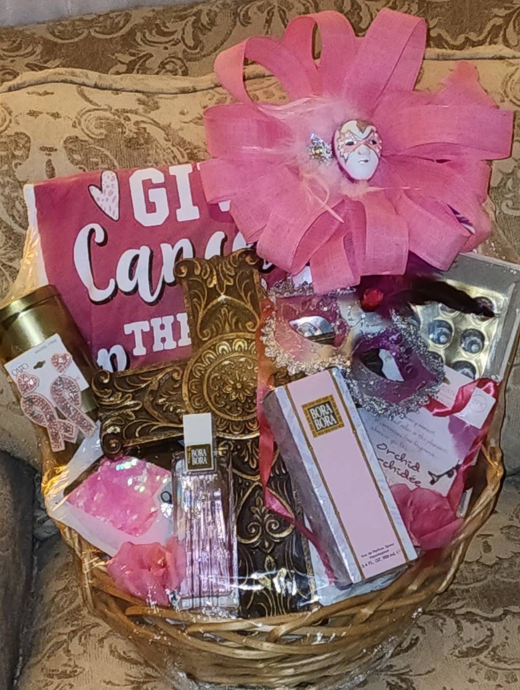 Pink cancer awareness basket with cross, jewelry, and gifts