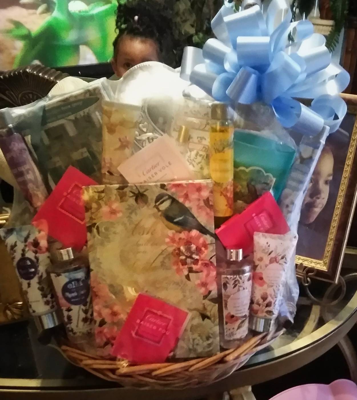 Luxury spa and beauty basket with lotion, body spray, candle, and chocolates