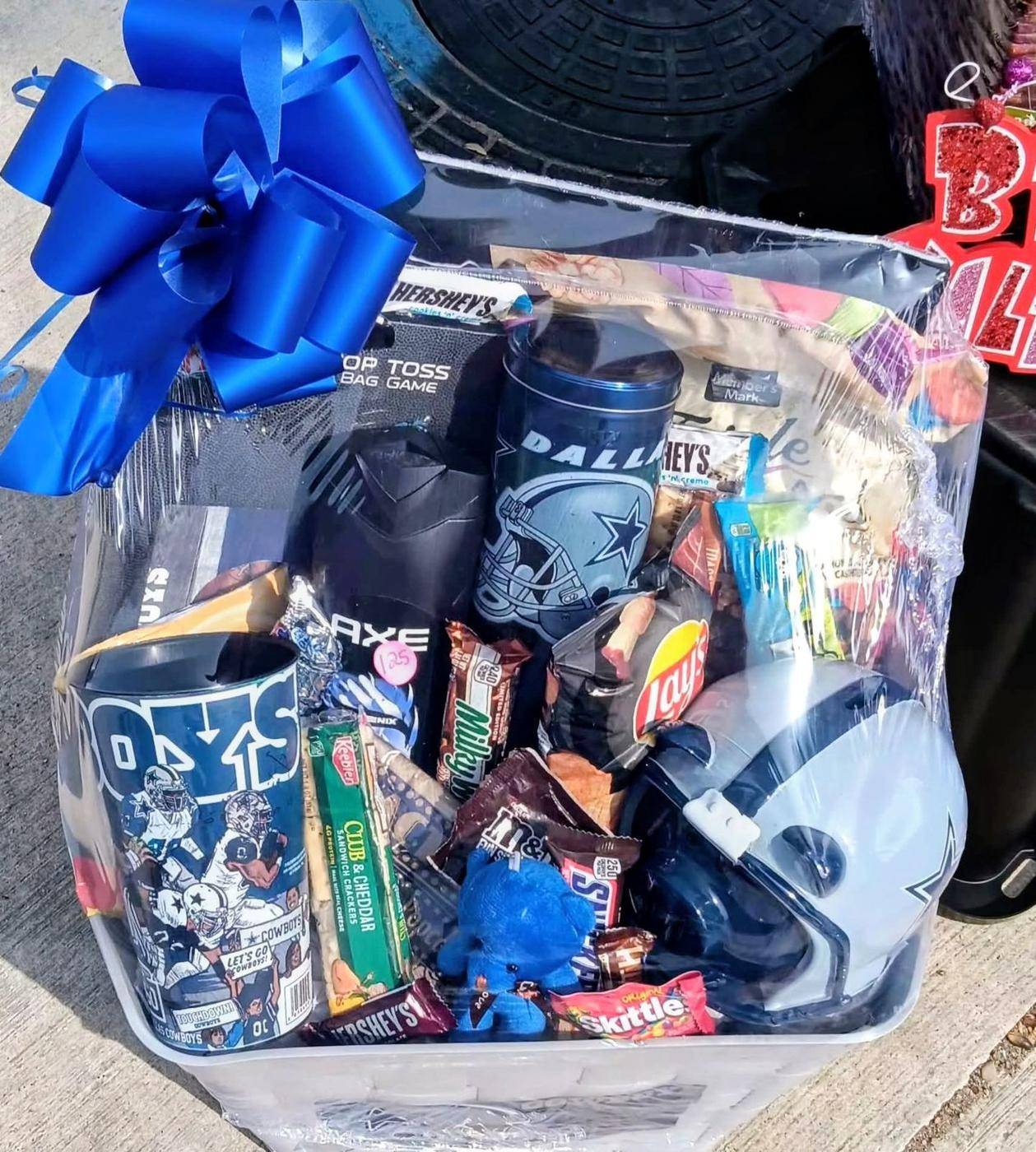 Dallas Cowboys deluxe gift basket with helmet, tumblers, snacks, and blue bow