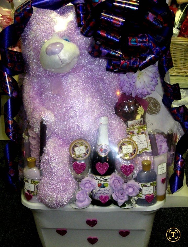 Valentine heart tub with white teddy bear, bath products, and sparkling cider