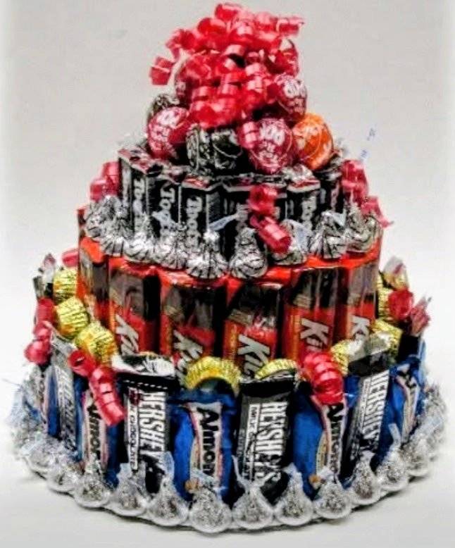 Candy bar cake made of Hershey's, Tootsie Rolls and Almond Joy with red ribbon bow