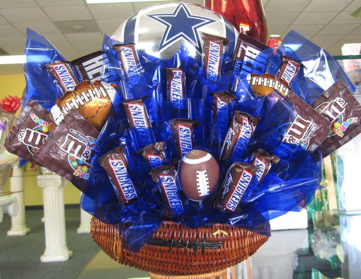 Dallas Cowboys chocolate candy bouquet with Snickers and M&Ms in a football basket