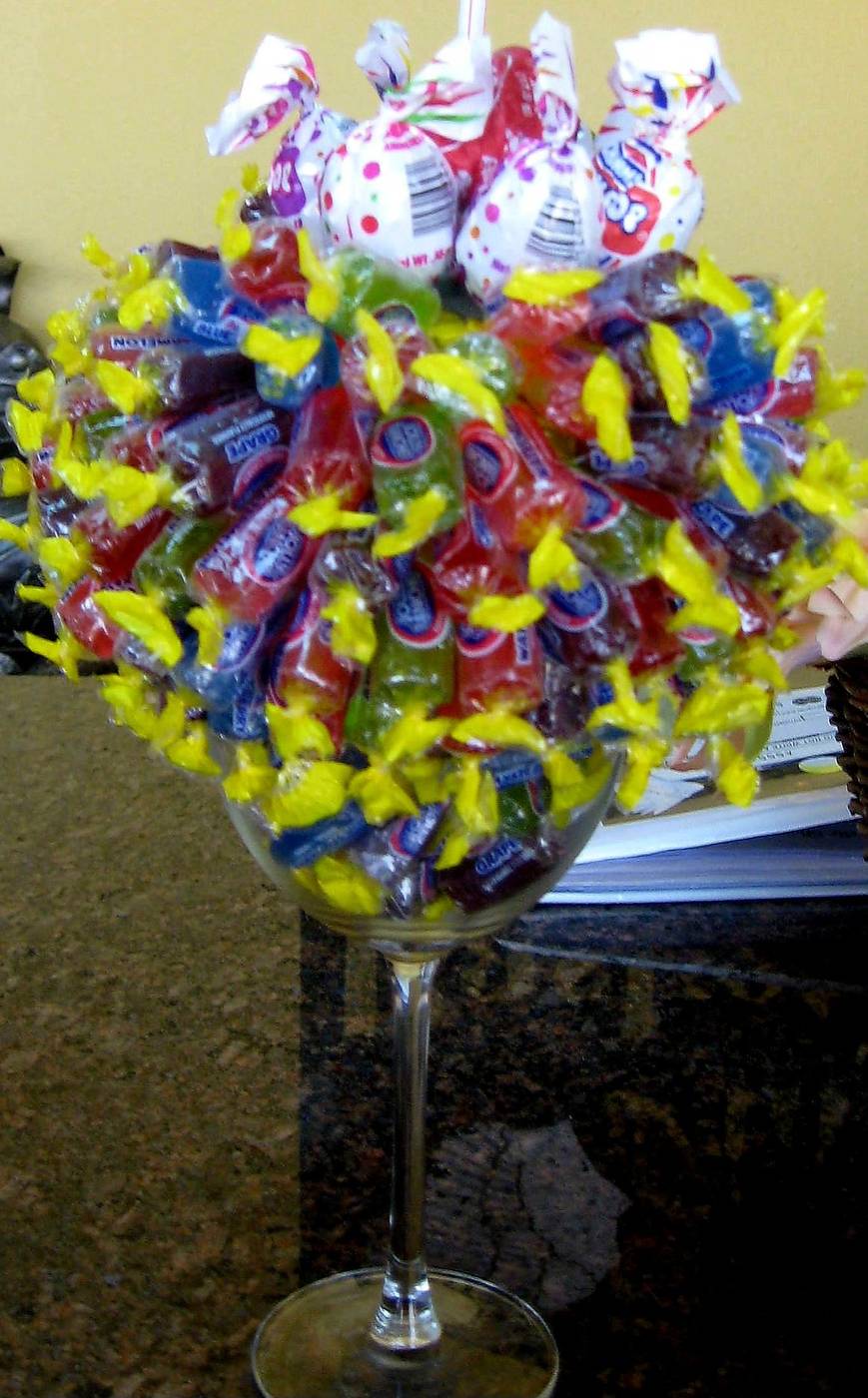 Colorful wrapped candy bouquet in a wine glass topped with lollipops