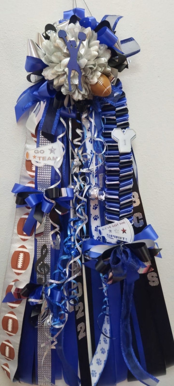 Blue silver and black homecoming mum with cheerleader, football and spirit ribbons