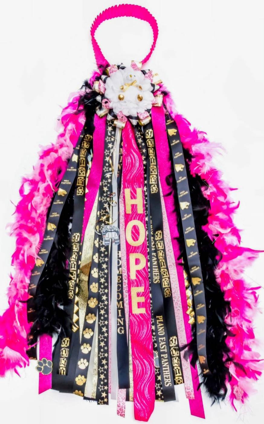 Pink black and gold homecoming mum for Hope with Plano East Panthers ribbons and feathers