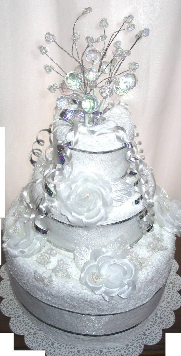 White and silver towel cake with crystal branch topper